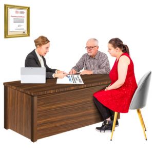 A man and woman sit across from a woman at a desk in an office, reviewing human rights documents together. A framed certificate hangs on the wall, while a tablet and papers clutter the desk. The man with glasses speaks as the woman in red listens attentively. they are writing a will to plan ahead